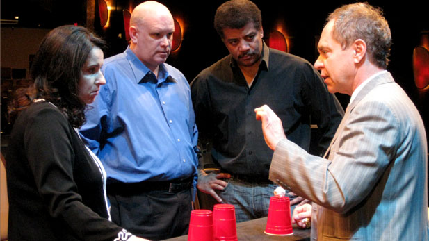 Neuroscientists Susana Martinez-Conde and Stephen Macknik and NOVA scienceNOW host Neil deGrasse Tyson observe Teller, the silent half of comedy magic duo Penn & Teller, as he performs his famous cups and ball trick.