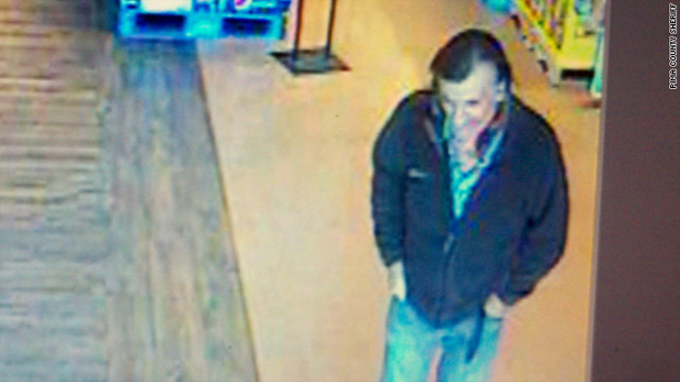 Surveillance camera photo of a man who was seen near the gunman just before Saturday's shooting.  Initially called a "person of interest," he has now been cleared of wrongdoing.