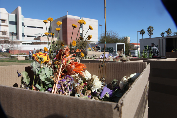 Flowers and other mementos were gathered by volunteers to be categorized and stored.