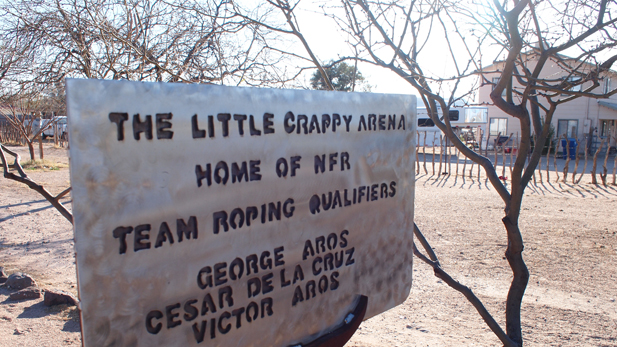 Victor Aros' scrappy front-yard sign commemorates his family's rodeo history.