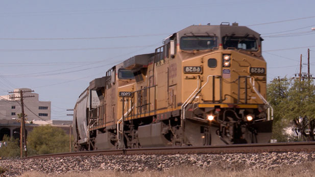 A Union Pacific freight train, pulled by two locomotives, rolls into the train yard southeast of downtown Tucson.