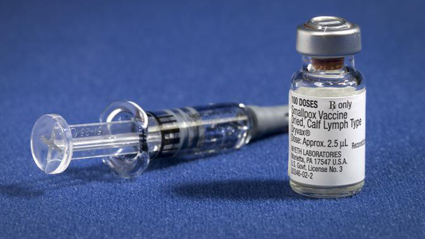The smallpox vaccine diluent in a syringe along side a vial of Dryvax® dried smallpox vaccine.