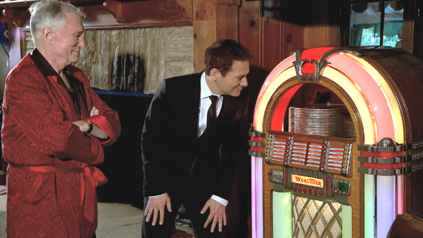 Michael Feinstein (right) inspects a vintage jukebox owned by Hugh Hefner (left).