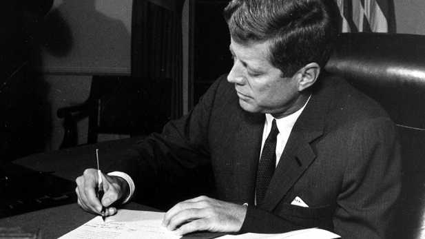 President John F. Kennedy signs the quarantine order.