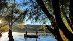 Rebecca Brukman. 10/22/12.
Two fishermen in boat at Lake Patagonia surrounded by trees and other natural scenery.
