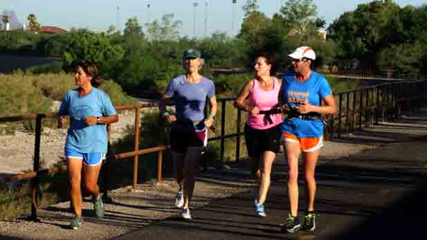 10/29/12. Rebecca Brukman.
Group of women in brightly colored athletic apparel run along path. 