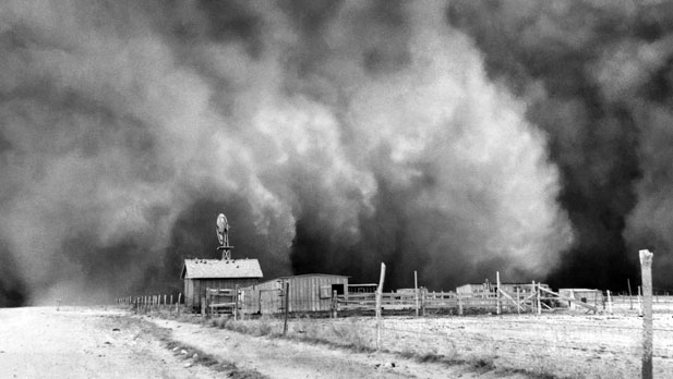 The storm sweeps over a farmstead on its way toward Boise City.