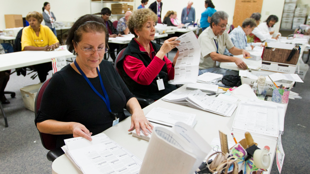 Pima County Elections Department workers process early ballots after the 2012 election.