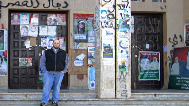 Tucsonan David Shellouff on his visit to Libya, with posters depicting martyrs of the Arab Spring.