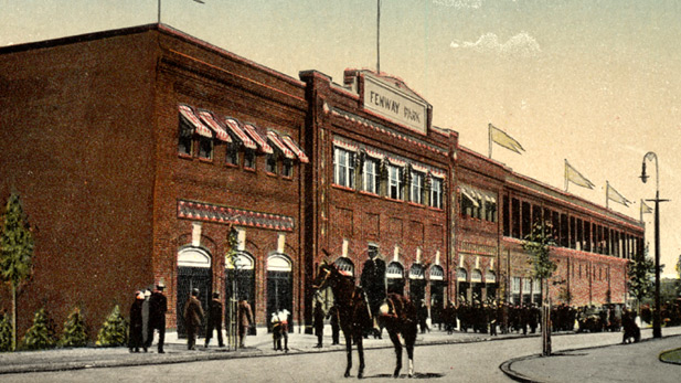 A policeman on horseback stands outside Fenway Park; colored photograph.