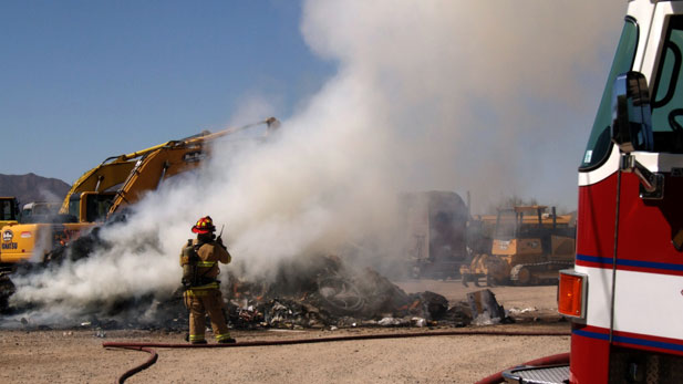 stock firefighter on walkie talkie at fire Spotlight 