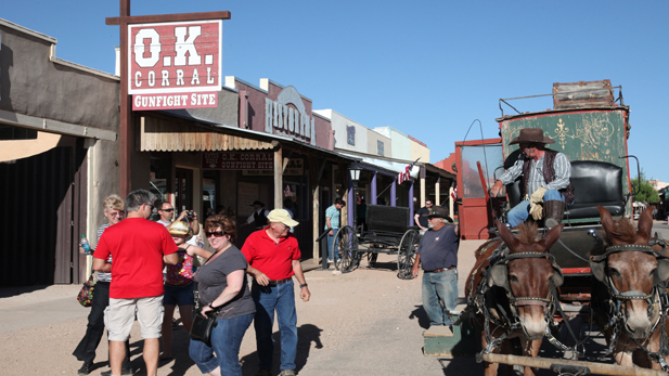 Tourists gather around a horse-drawn carriage in Tombstone.