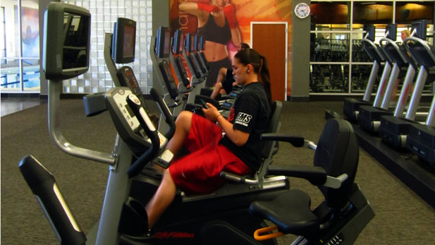 stock woman working out at gym spotlight
