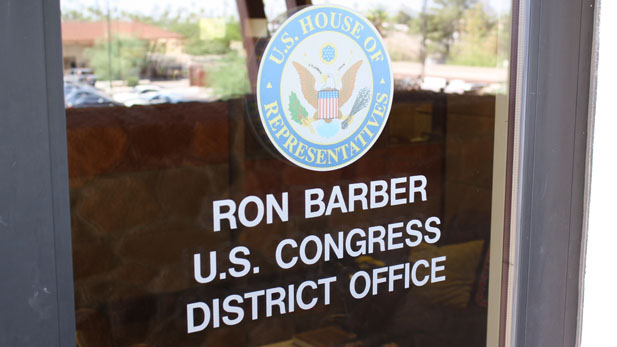 The front door to the Congressional District 8 office in Tucson reflects Democrat Ron Barber's victory two days after the special election to fill the vacant seat in Congress.