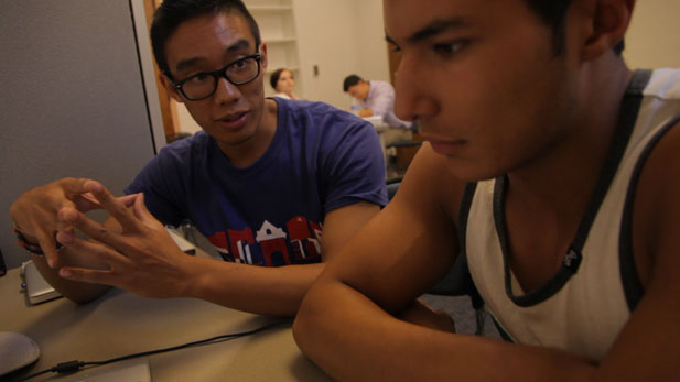 New Start participant Fernando Garcia (right), receives tutoring on writing papers for university classes.
