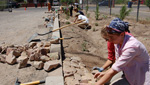 Volunteers with Watershed Management Group redesign a neighborhood street to help capture rain water to be used in growing plants.