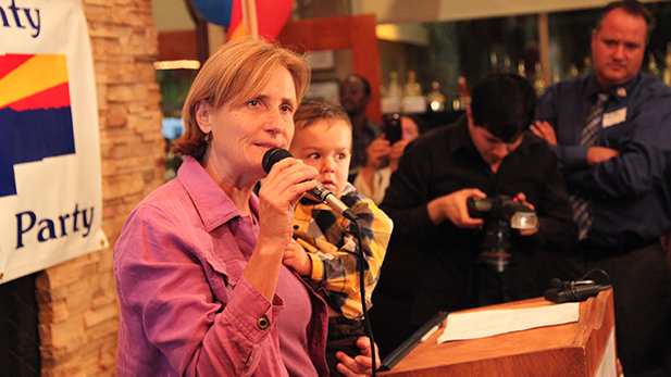 Tucson City Council member Karin Uhlich, holding her foster son Isaiah, at the Democratic Party gathering on election night, Nov. 5, 2013.