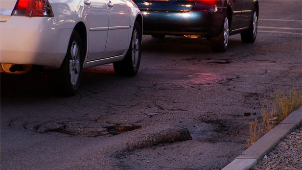 Street with potholes spot