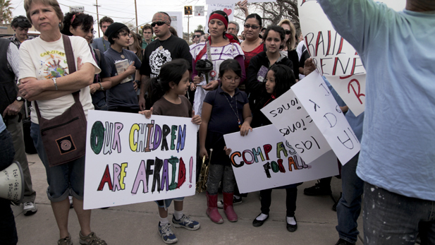 A group of about 100 people protest enforcement of SB 1070 outside of Tucson Police Department in downtown Tucson.