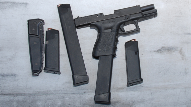 The Glock 9 mm gun Jared Lee Loughner used to kill six and wound 13 in the Jan. 8, 2011 shooting in Tucson. Shown with additional ammunition magazines recovered at the scene and a knife (left) that Loughner was carrying.