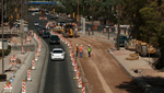 Downtown traffic makes its way through construction in the area where the new street car will be.
