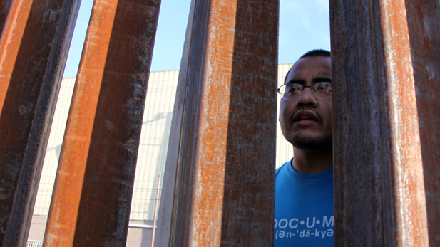 Marco Saavedra, 23, at border fence in Nogales last month. His asylum request was pending.