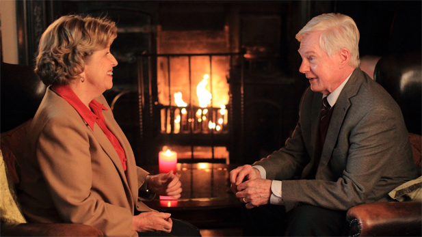 Alan and Celia sit by the fireside in a café.