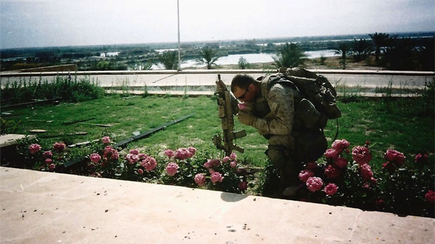 Soldier smells a flowers in a garden after returning from abroad.