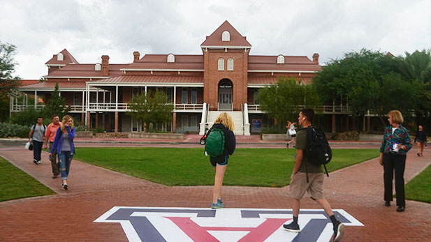 Students walk by Old Main SPOT