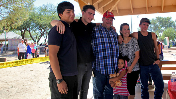 Tyler (second from left) celebrating his adoption into the Woelfle family with his new parents and siblings. 