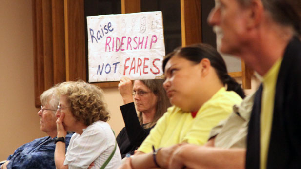 Members of the Tucson Bus Riders Union protest proposed bus fare increases outside the Tucson City Council meeting Feb. 19, 2014.