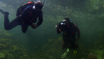 Christopher Conover, a corespondent for Arizona Public Media and a scientist from Biosphere 2 dive in the facilities fully replicated ocean.