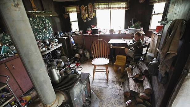 Johnny Noble, 9, sits in his uncle's trailer during a visit on April 21, 2012 in Owsley County, Kentucky. Photo by Mario Tama/Getty Images