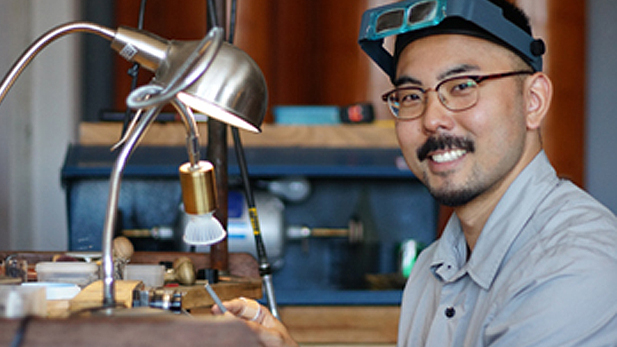 Jeweler Shane Yamane works at the bench to create a rose cut diamond ring, 