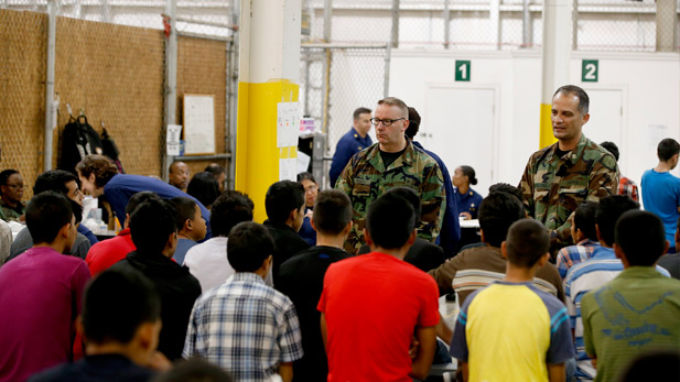 Federal agents address Central American children at a Nogales shelter in summer 2014.