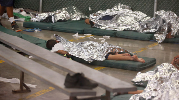 Child sleeps in one of the holding areas for Central American kids shelter in Nogales, Ariz.