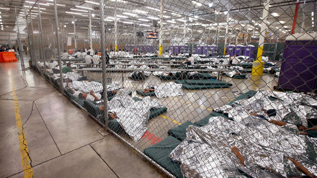 Children sleep on mattresses without pillows, covered with foil blankets.