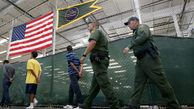 Teens walk into Nogales shelter escorted by Border Patrol officers for processing