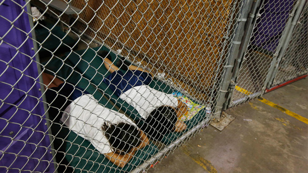 Children sleep on 4-inch mattresses in one of the shelter's holding areas.