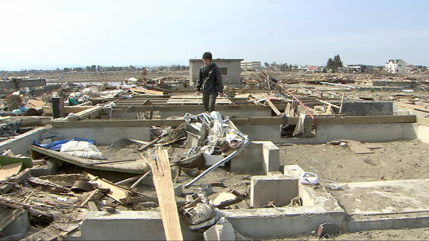 A survivor walks amid the rubble.