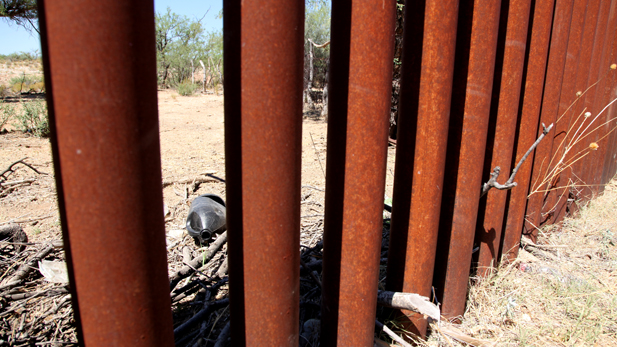 Water jug through border fence spotlight