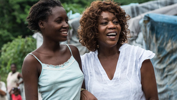 Alfre Woodard with a young girl on location for A Path Appears in Haiti.