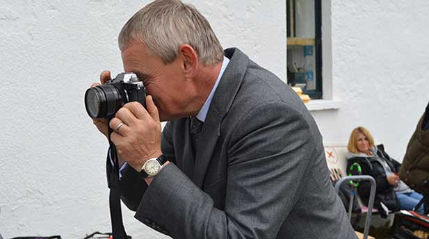 Martin Clunes taking photos on set