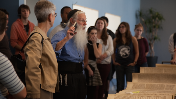 Rabbi Gedaliah Druin explains to students and faculty his techniques for repairing an ancient Torah.