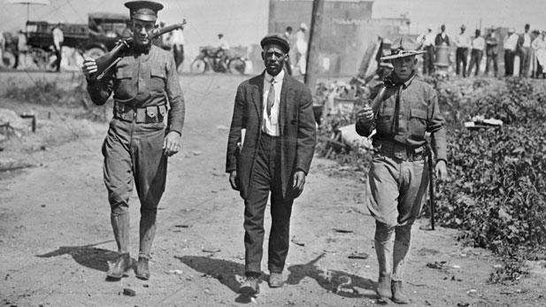 National Guardsman escorting man around the time of a race riot in East St. Louis, June 6, 1917.