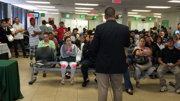 Border Patrol Agent George Trevińo speaks to Mexican immigrants at the Mexican consulate in Phoenix.