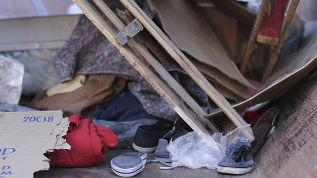 Clothing, wood scraps and blankets are pictured in a City of Tucson dumpster on Friday, March 13, 2015. The trash was from the deconstruction of the Safe Park protest in downtown Tucson. 