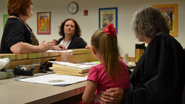 Family Drug Court Judge Susan Kettlewell (right) and her granddaughter listen to discussion on a family reunification.