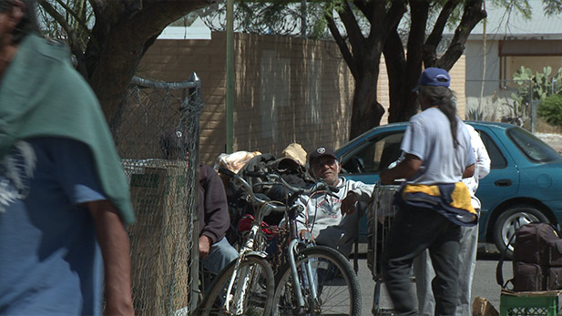 Soup kitchen workers hand out food to the homeless.