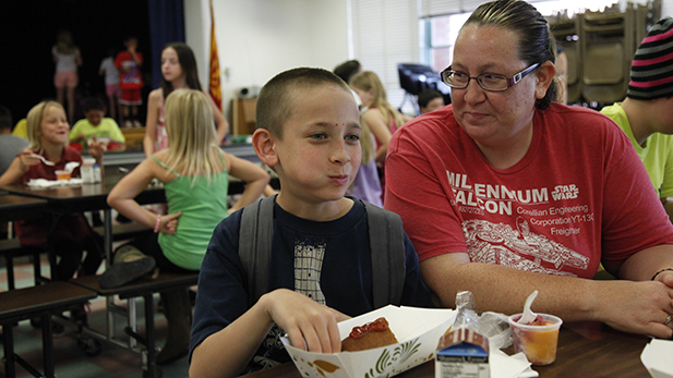 Johnny Collins, 8, is attending summer school at Kellond. His mom, Stephanie Collins, said the free meals ease the strain on the family's budget. 